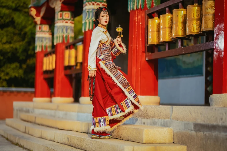 woman in a traditional chinese garb carrying a small item