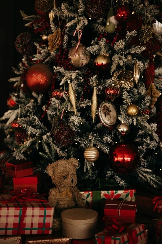 a decorated christmas tree with presents underneath it
