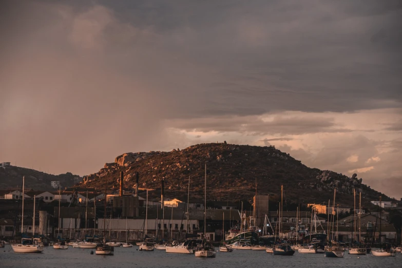 the mountains are in view and boats are in the water