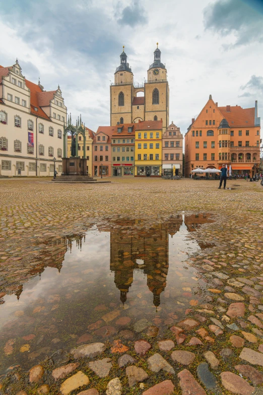 a dle with water near large brick buildings