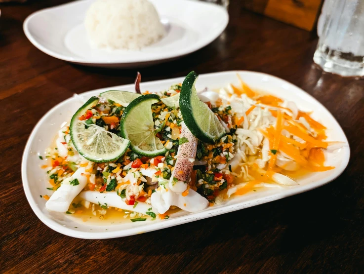 a platter of food with meat, vegetables and rice