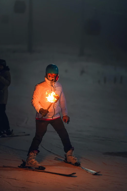 a person riding skis down the snow covered slope