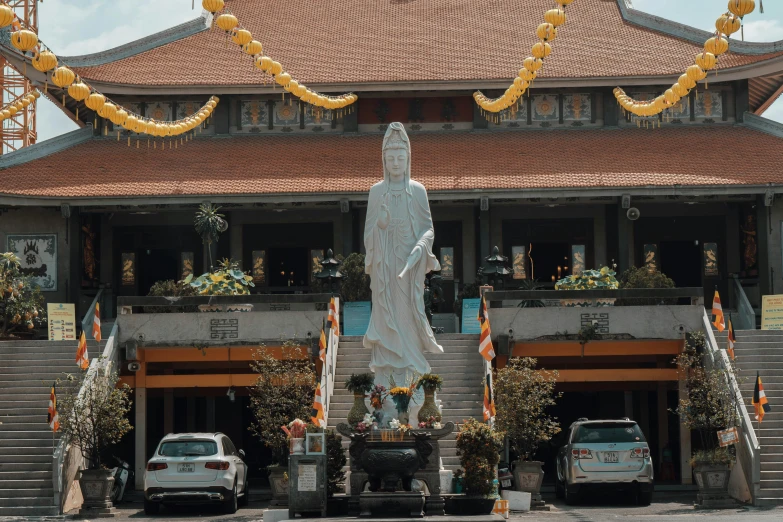 the entrance to a chinese restaurant with a statue of a woman