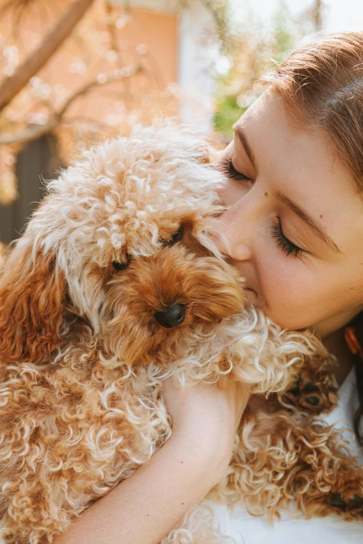 a woman is petting a small dog