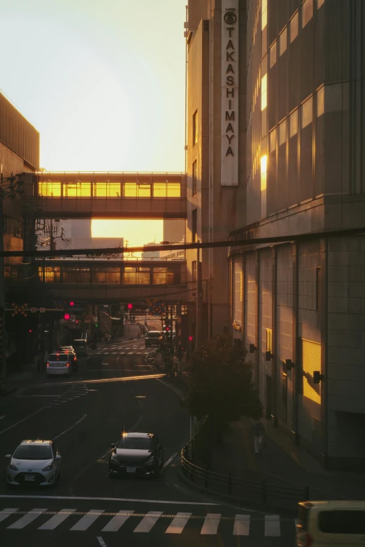 a city street at dusk with buildings and cars parked