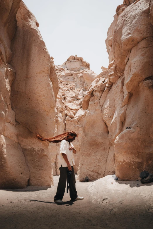 a man in a desert setting holding a frisbee