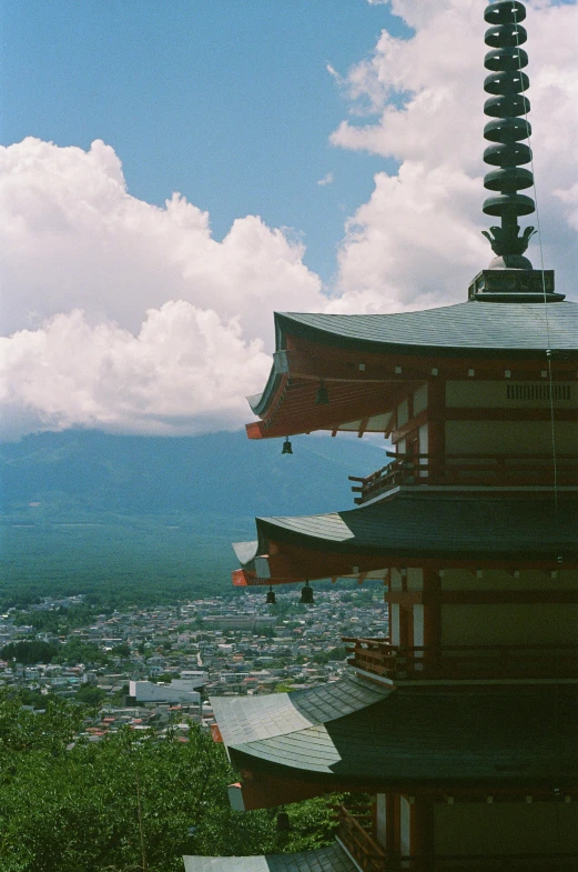the skyline is full of mountains, clouds, and pagodas