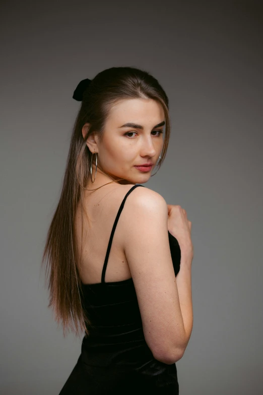 a woman with an elegant ponytail looks away from the camera