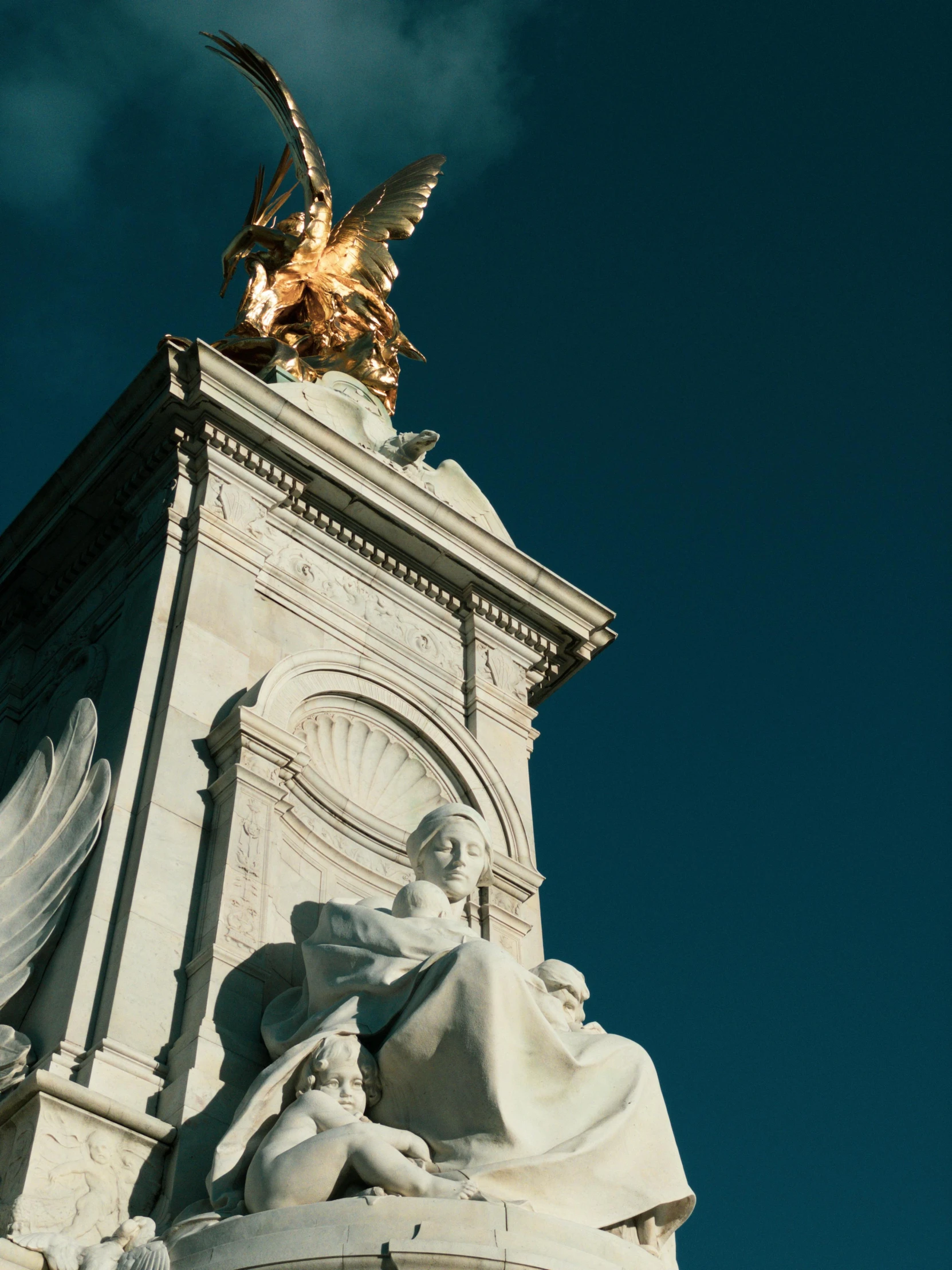 a statue with an eagle on top sitting underneath the moon