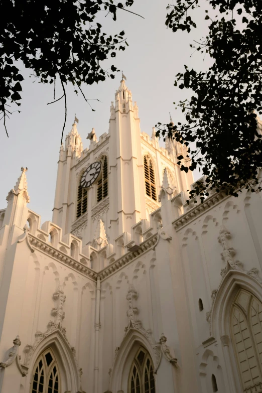 the steeple and window on this old, historic building provide an contrast to another building