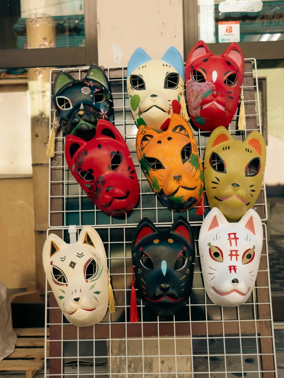 a bunch of different masks are placed on a wire rack