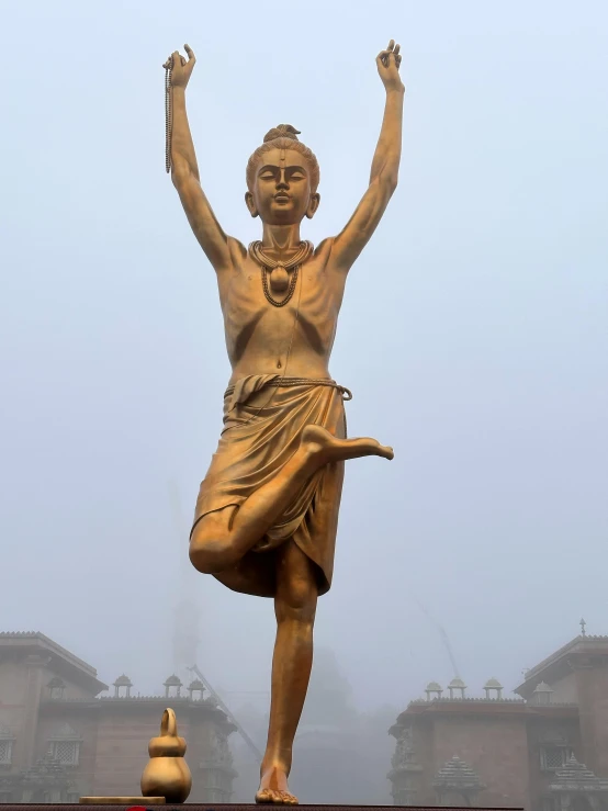 a statue stands on its hind legs and holds its arms raised