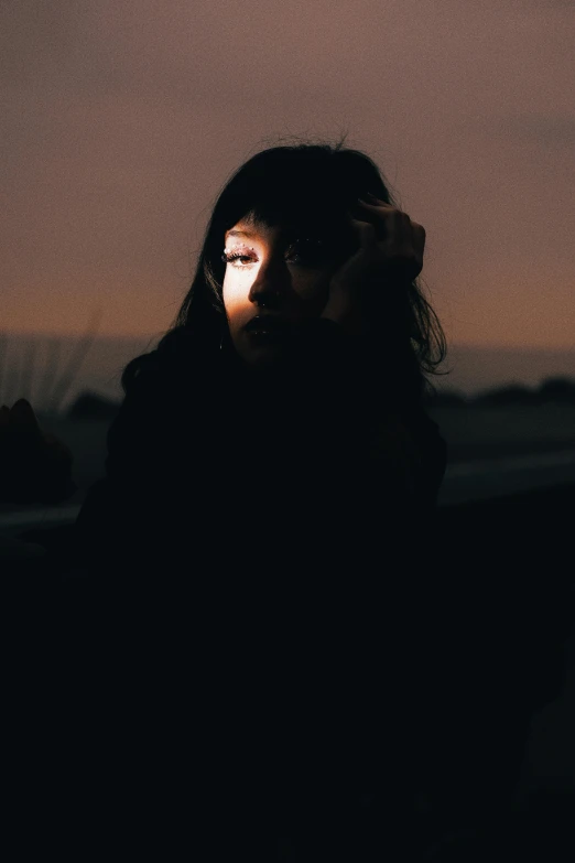 a woman looking down at the sky with her hand on her head