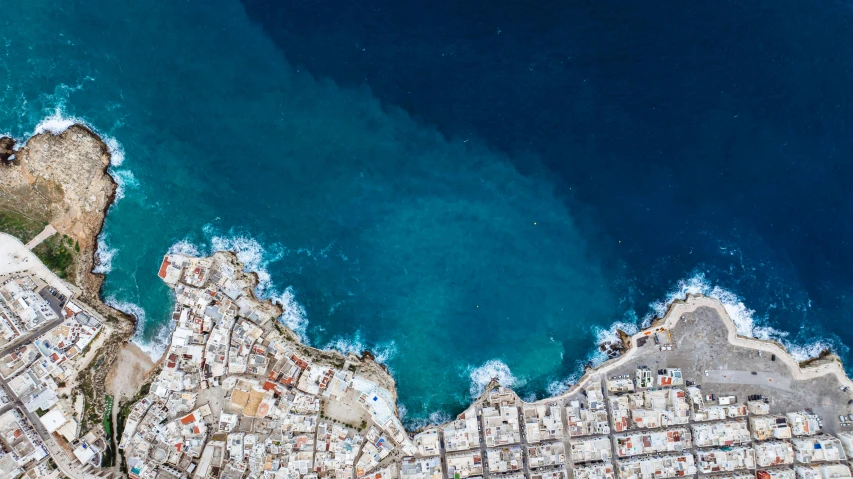 an aerial view of a coast with lots of buildings