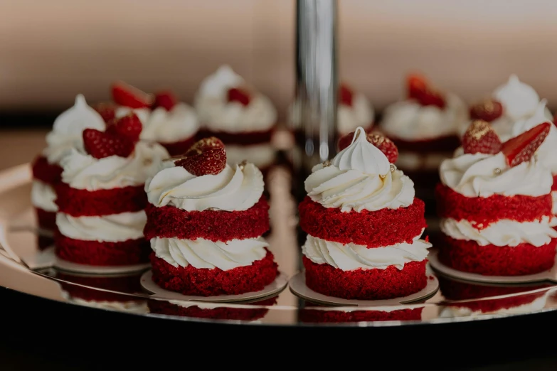 several cupcakes are displayed on a silver platter