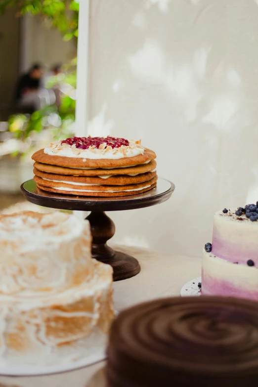 three tiered cake with berries and blueberries on top