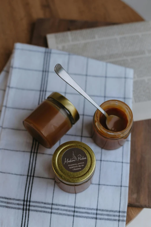 some food sitting on a table next to a jar