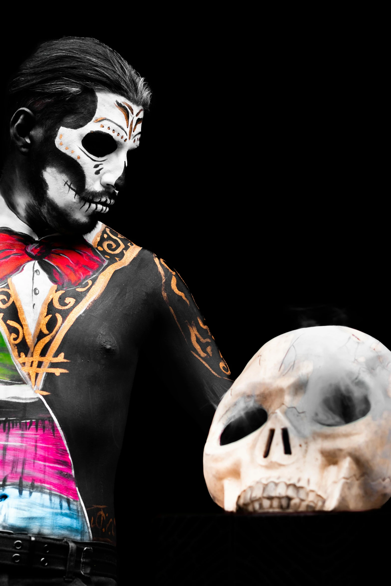 a skeleton holding an object in one hand and a mexican wrestler in the other