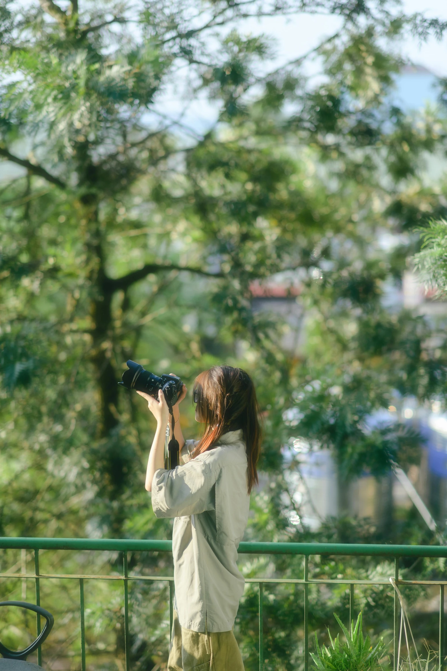 woman with short hair taking pos of trees