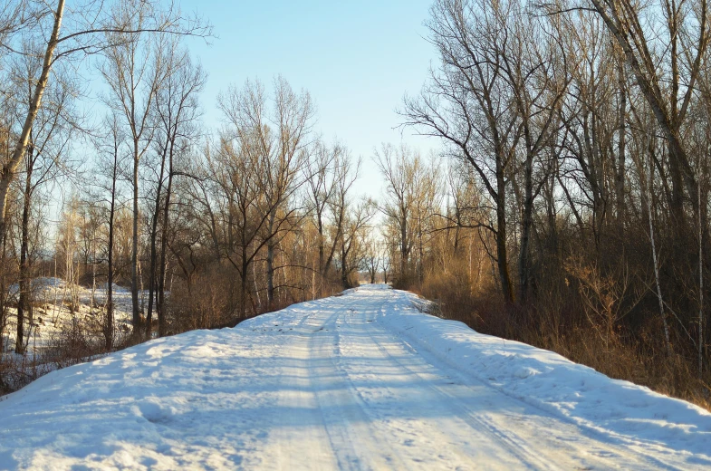 there is a snow covered road with no traffic