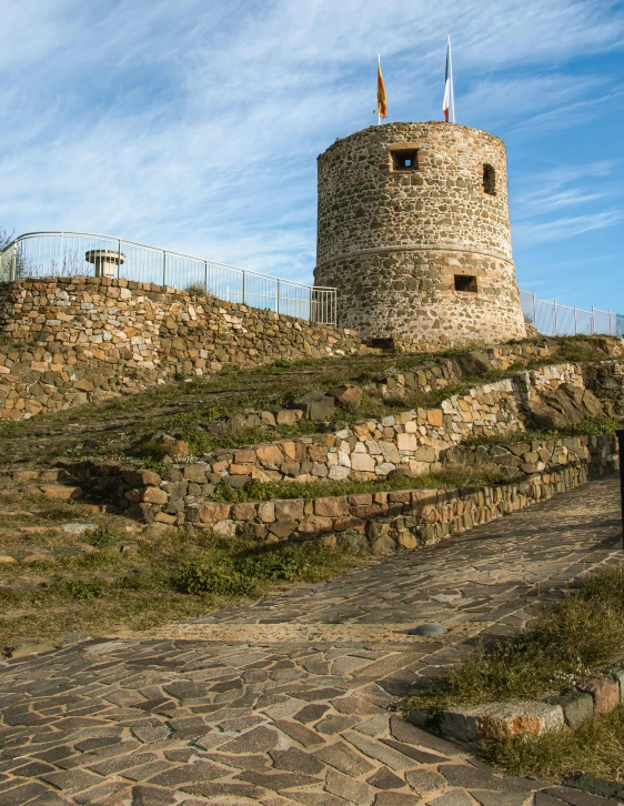 an old building sits on top of a hill