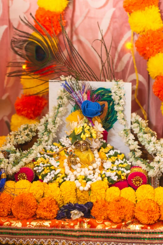 a statue of lord gan ganesh in a floral shrine