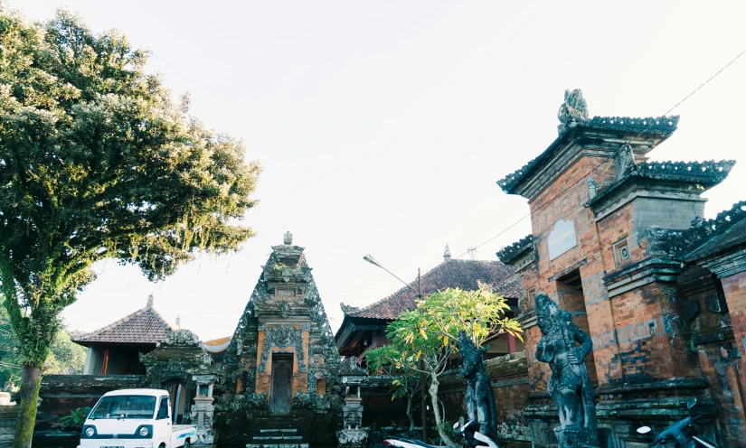 cars are parked outside a temple style area