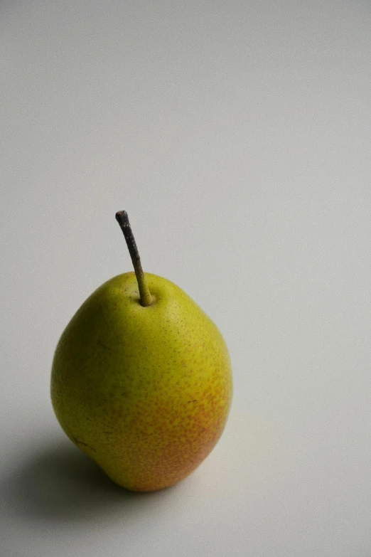 an apple with a brown stem and its bite sticking out