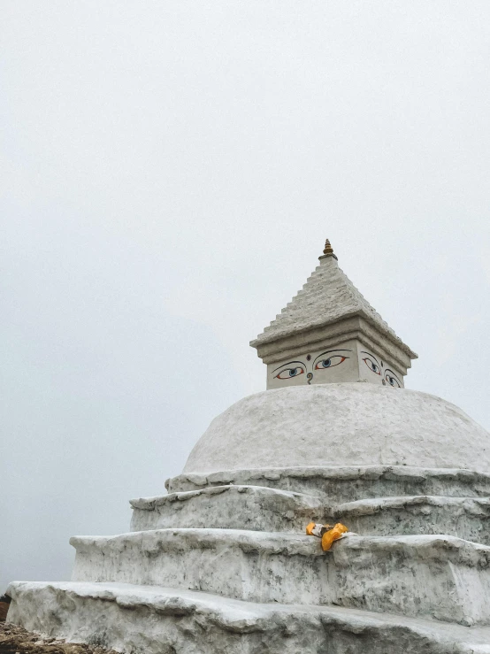 two people in the snow with an umbrella on the mountain side