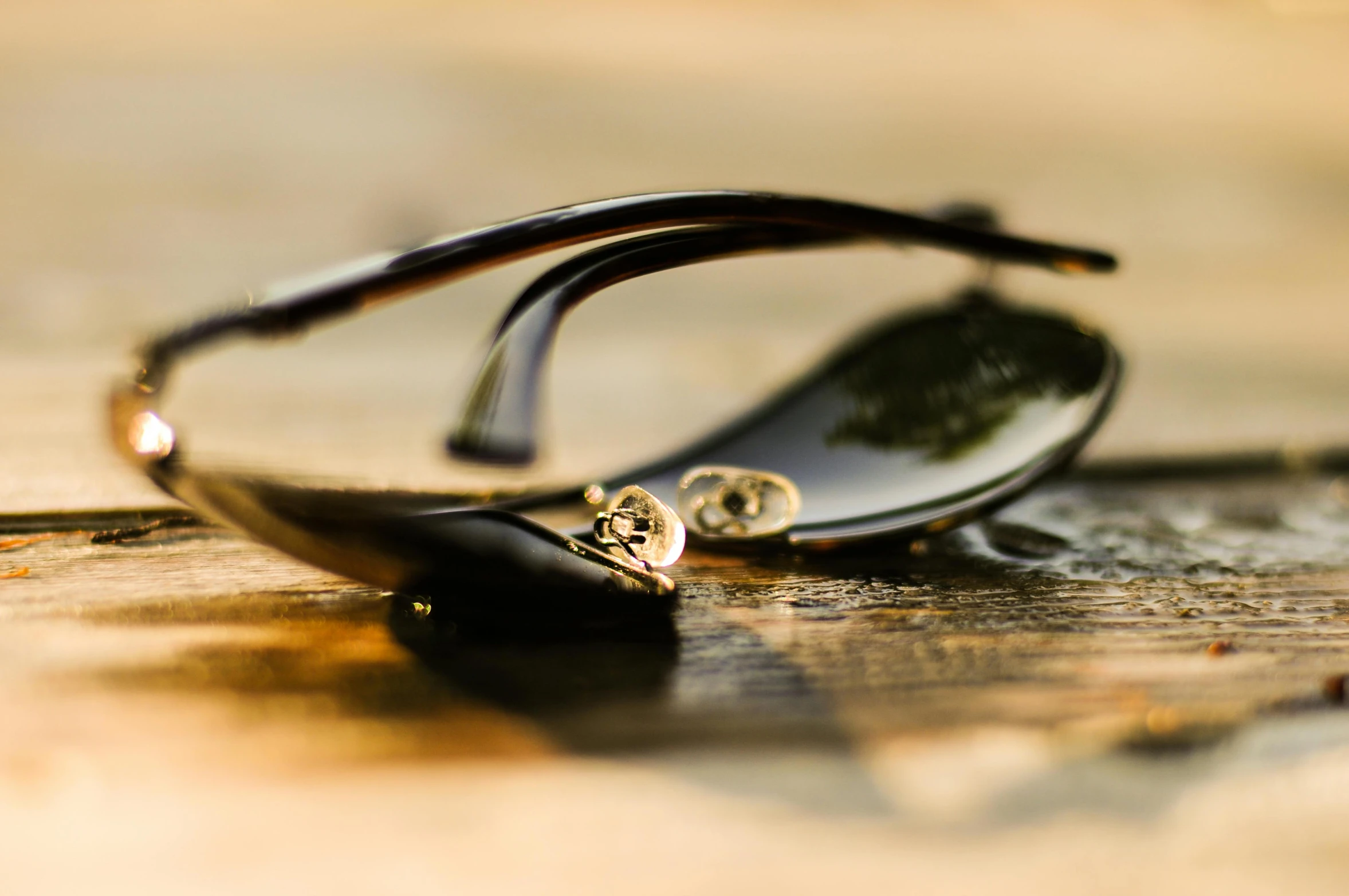 the reflection of a pair of glasses on top of a table