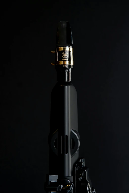 a black object with gold on it in front of a black background