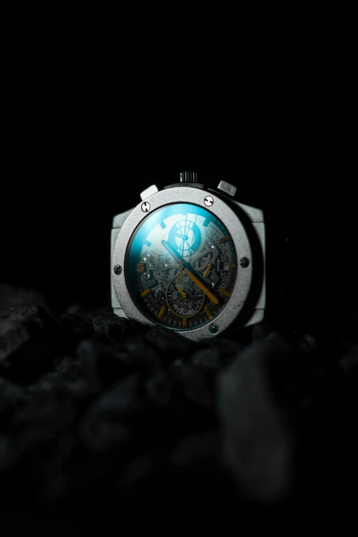 a watch sitting on a bed in the dark