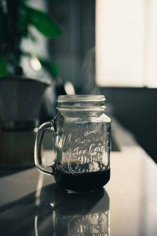 a clear glass mug filled with liquid sitting on a table