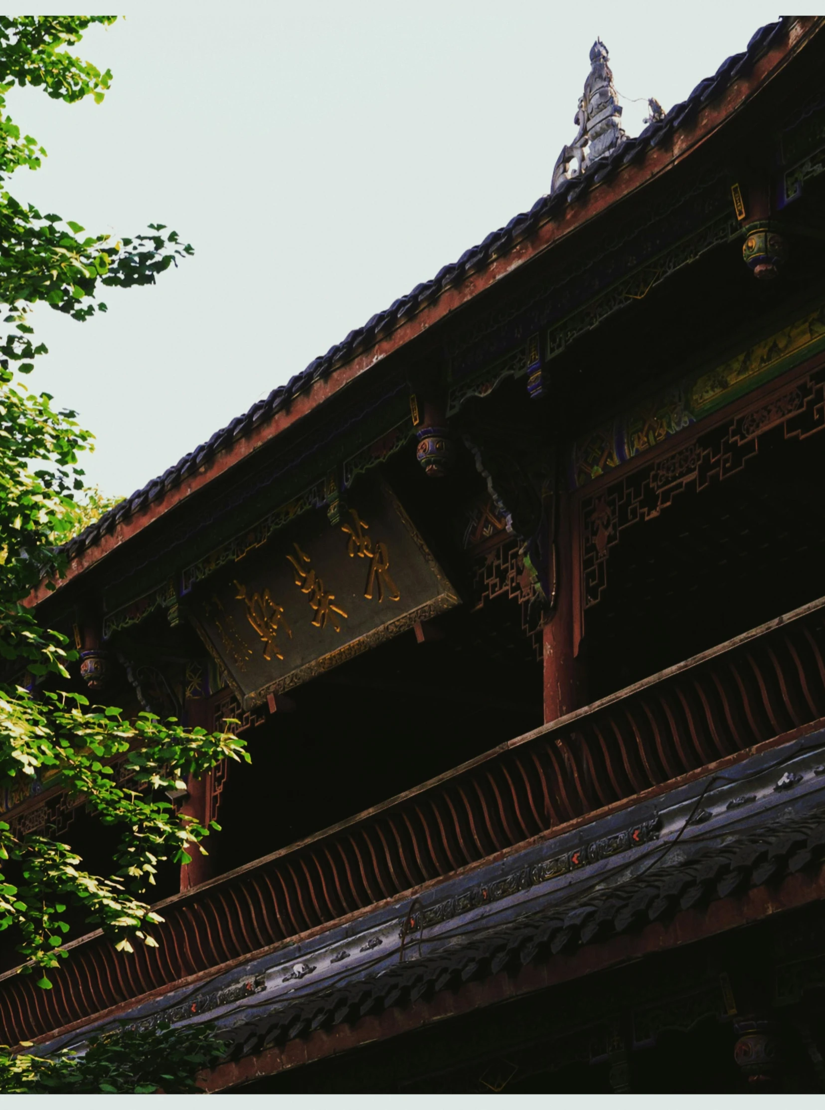 the roof of a building with a clock tower above it