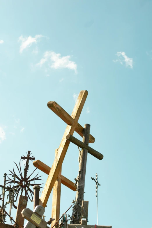a church steeple is made of wood and has a cross atop it