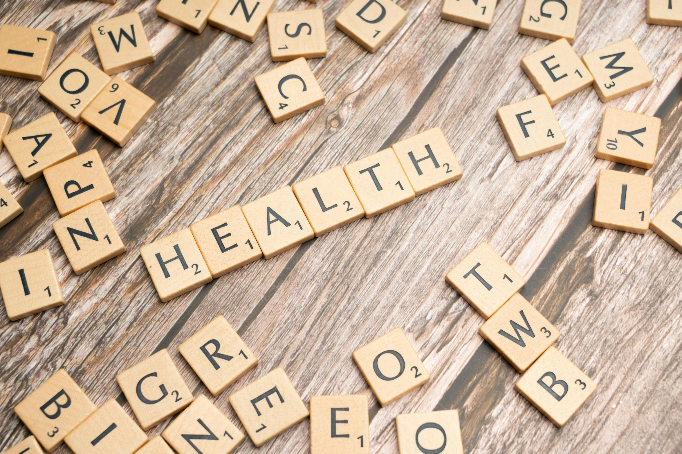 several scrabble letters that spell out the word health