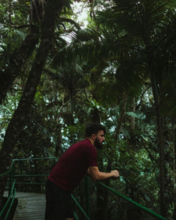 man running down stairs through the woods with a frisbee