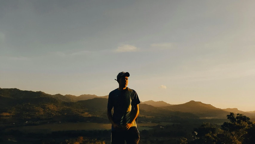 a person stands on top of a mountain