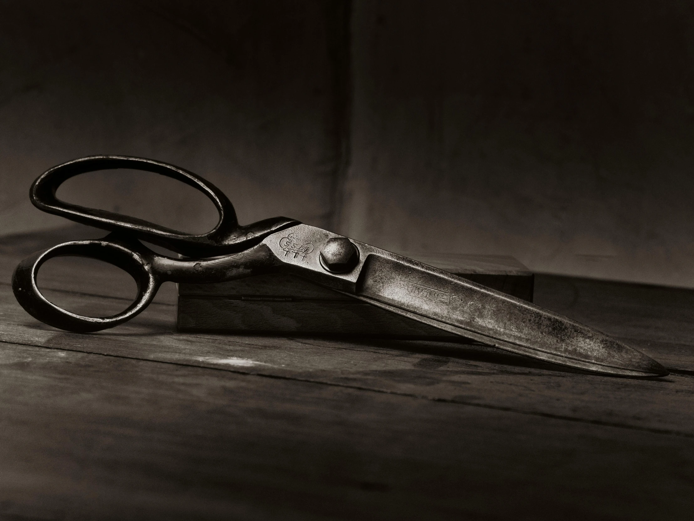 black and white po of a pair of scissors on the floor