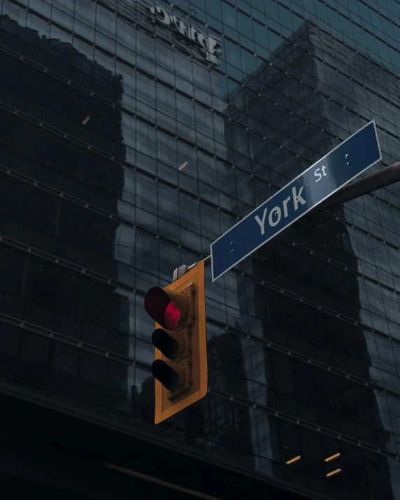 an intersection sign next to the yok building in nyc