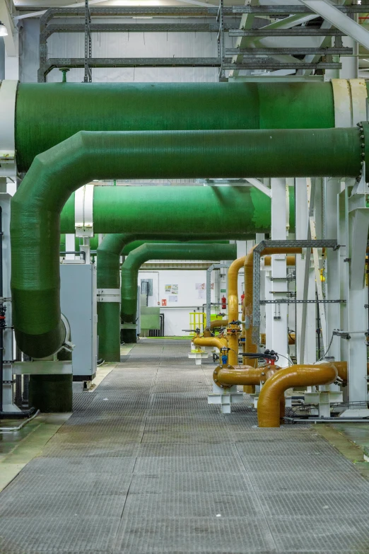 the interior of a factory showing many pipes, machinery and piping