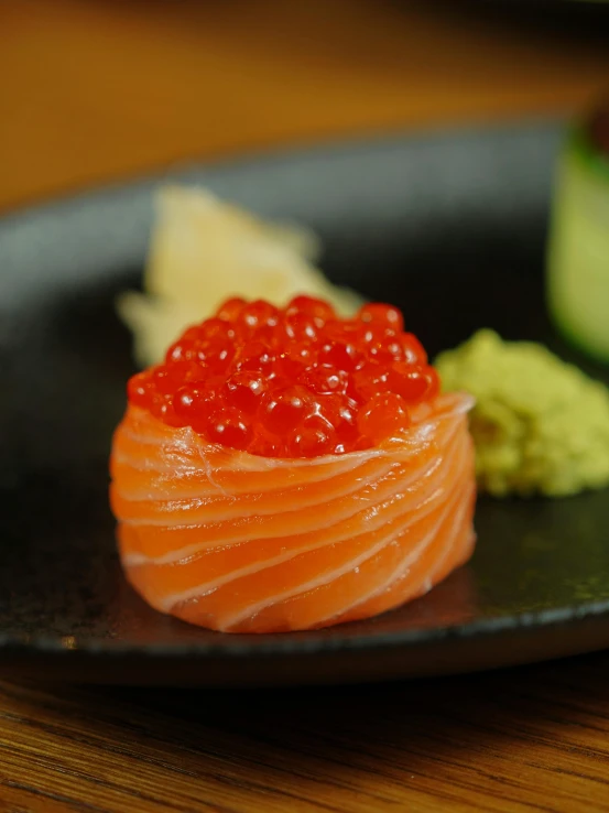 salmon served with garnish on a black plate