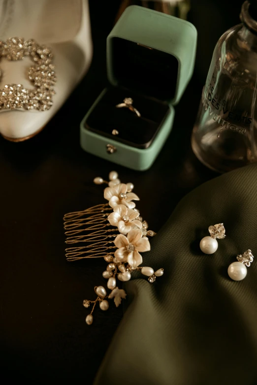 pearls and a wedding ring sitting in a bag next to some jewelry