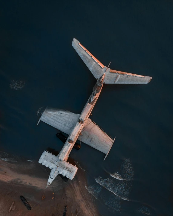 an airplane flies above water in a nighttime sky