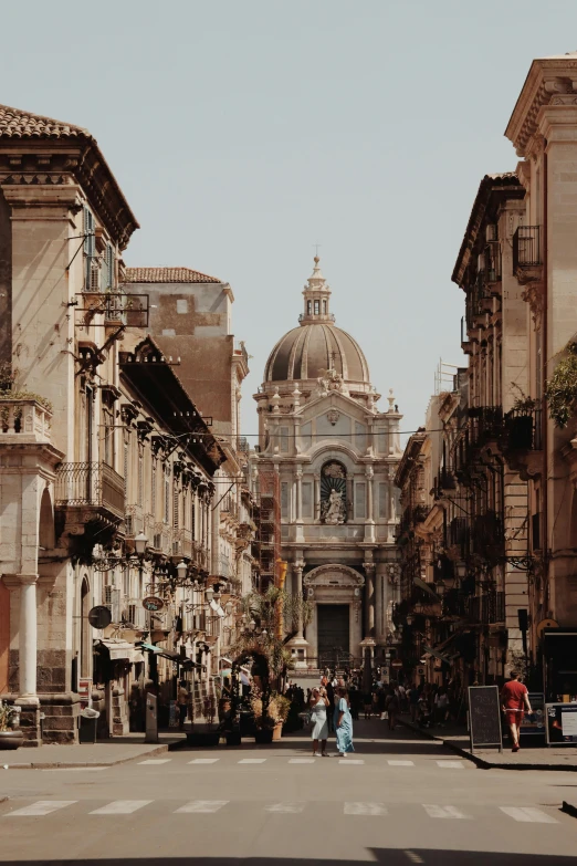 some buildings and people walking around on the street