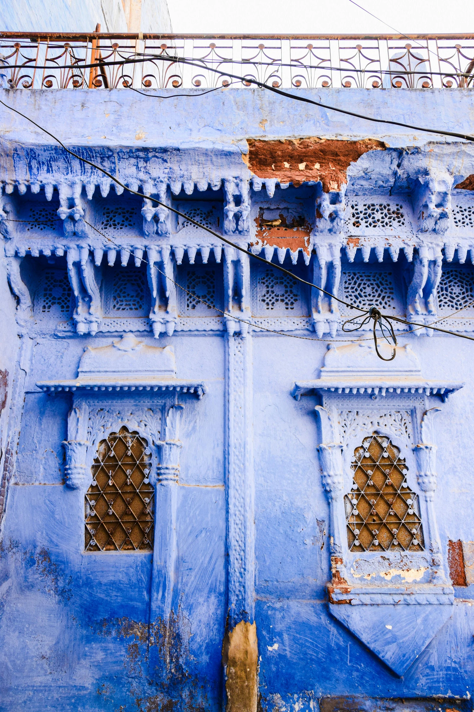 ornately painted blue building with a clock