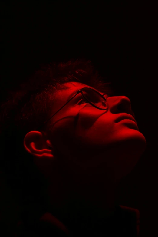 a man with dark glasses and a red light on
