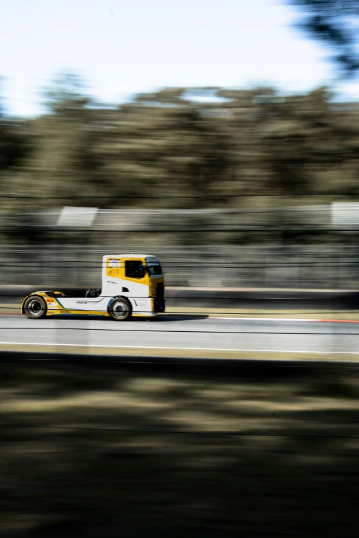 a truck riding on top of a race track