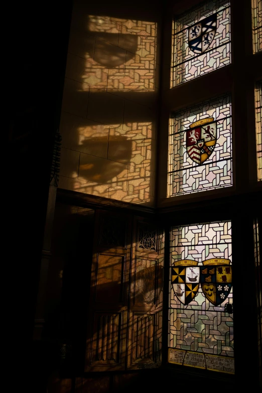 some stained glass is hanging on a wall