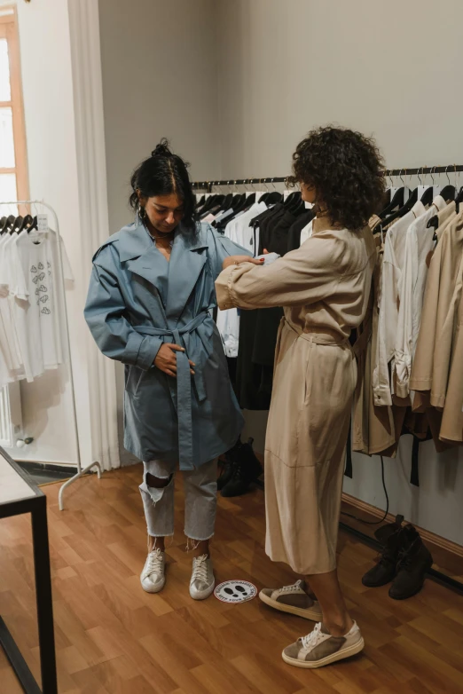 the two women are trying on their clothing